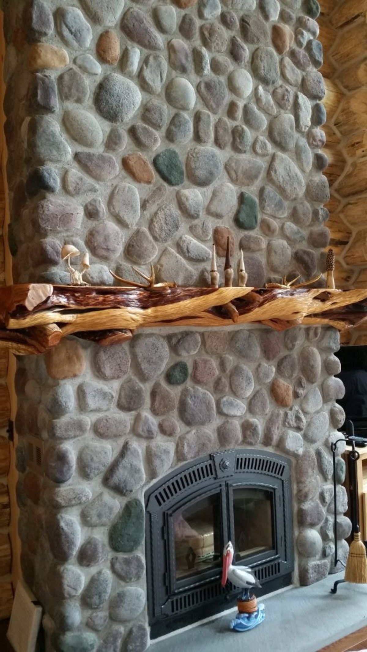 stone fireplace with live edge wood mantle