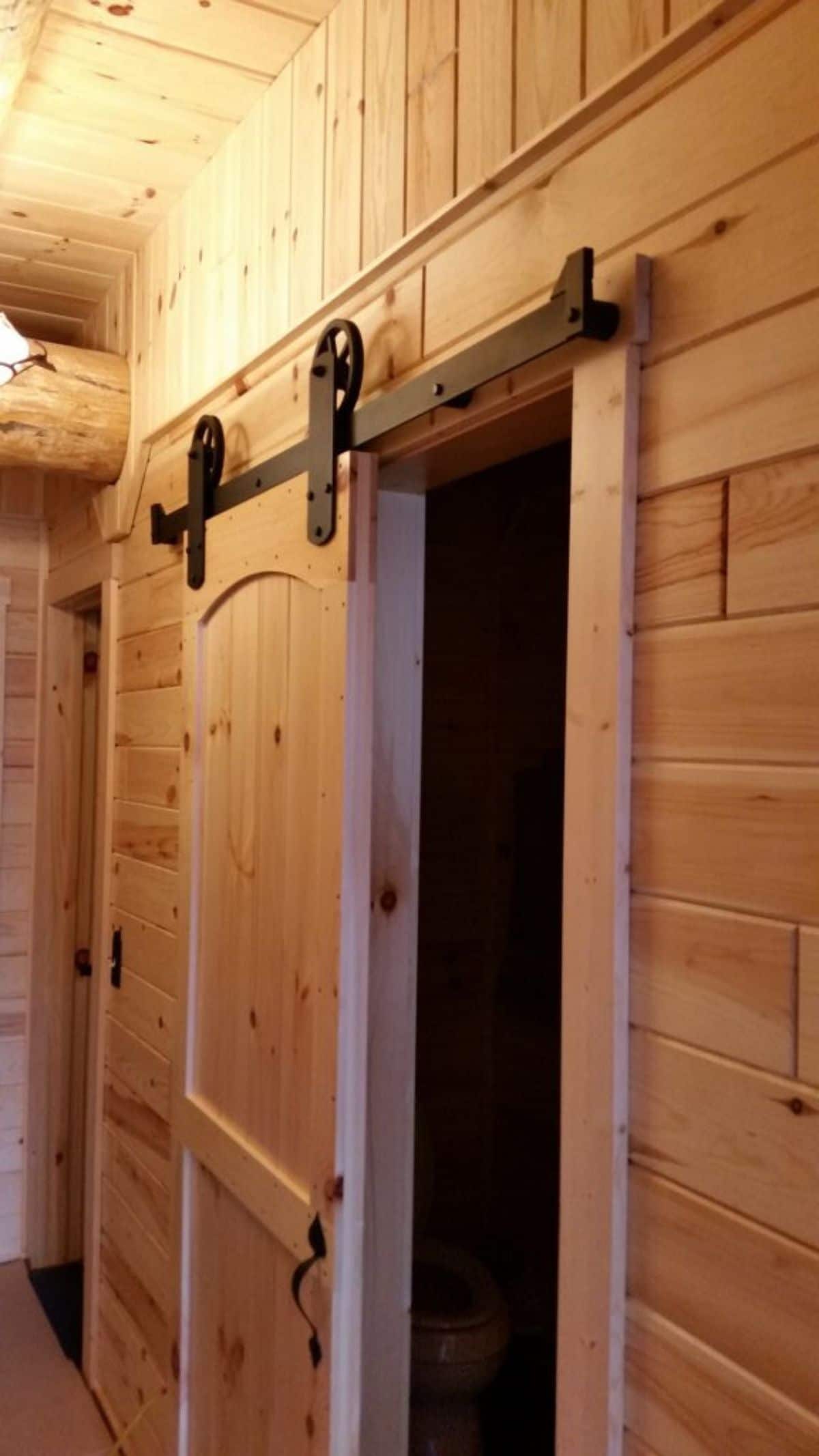 open barn door on closet with black hardware
