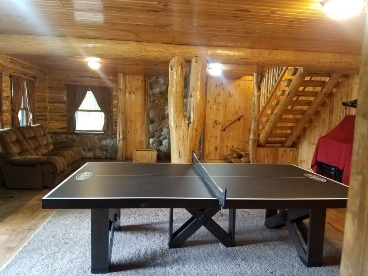 ping pong table in basement of log cabin
