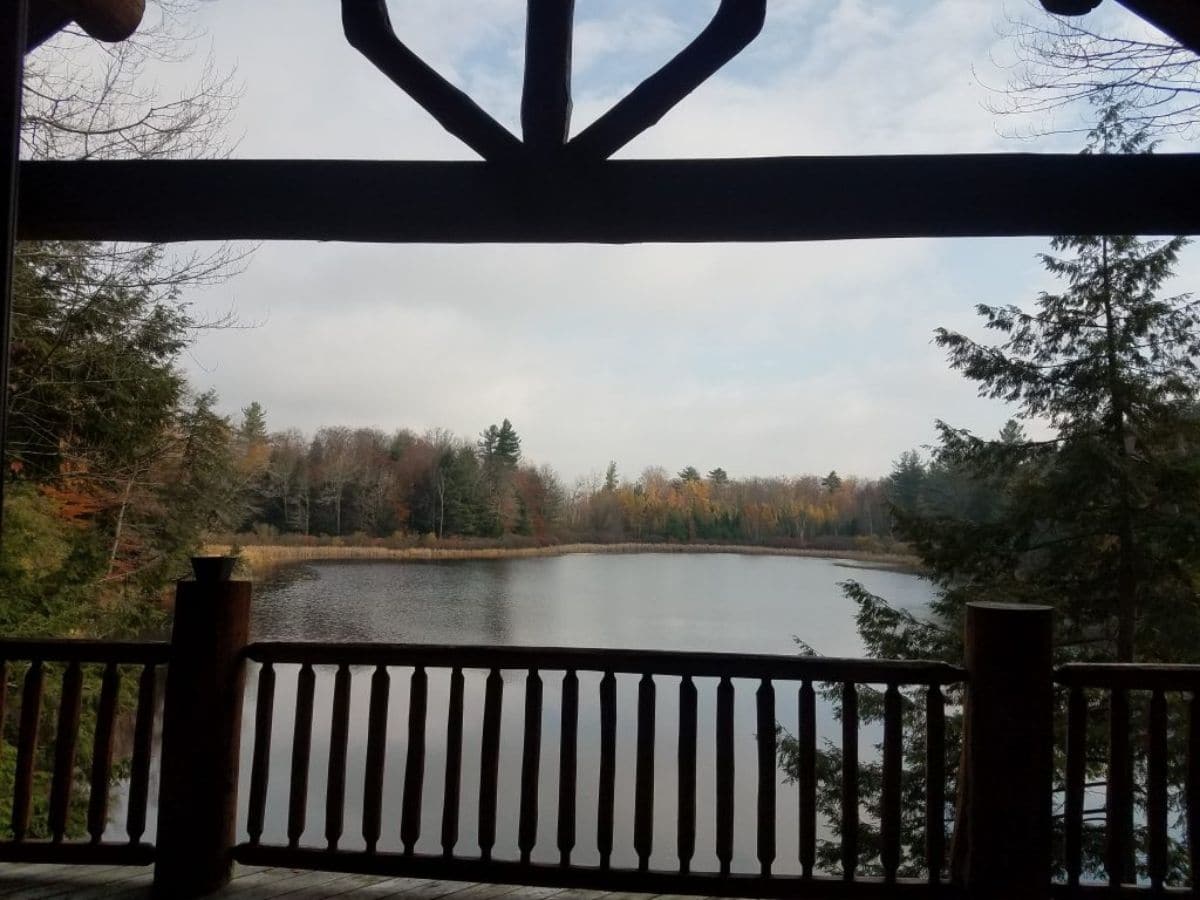 view of lake from balcony of log cabin