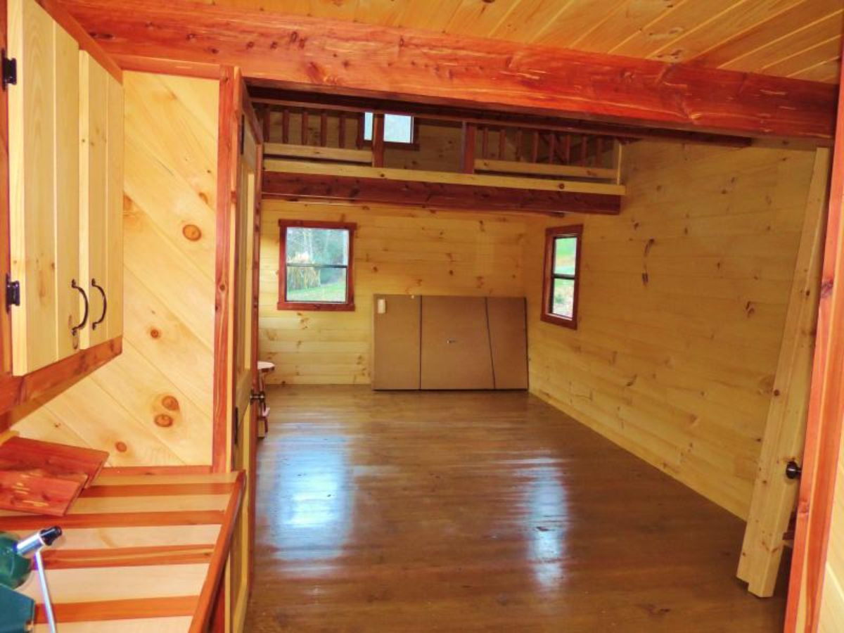 open space in log cabin with stained striped counter on left of image