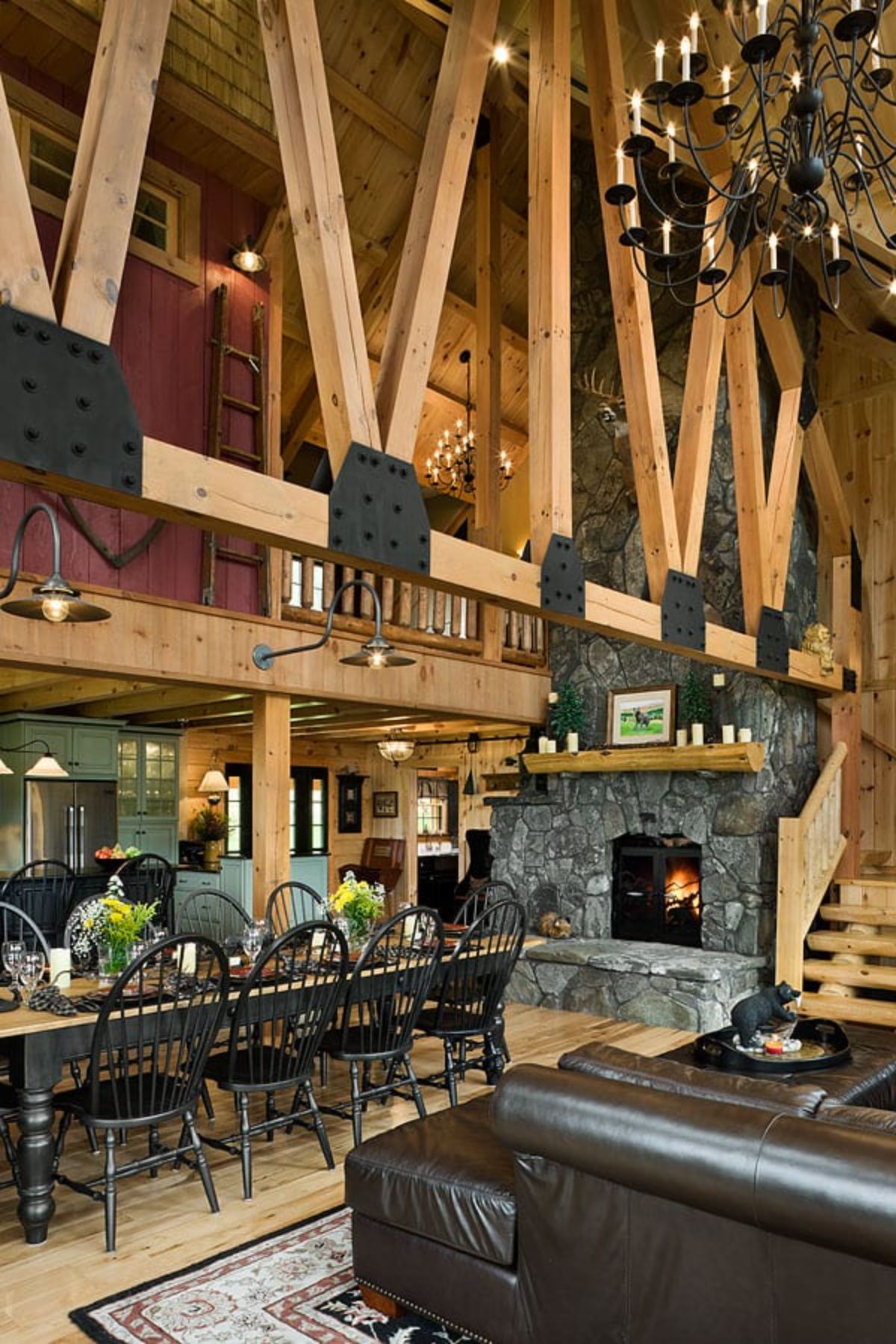 view from kitchen into living area with stone fireplace against back wall in image