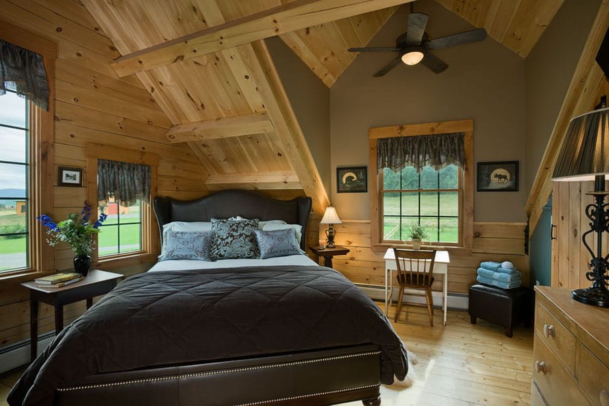 black bedding on bed at an angle in loft bedroom