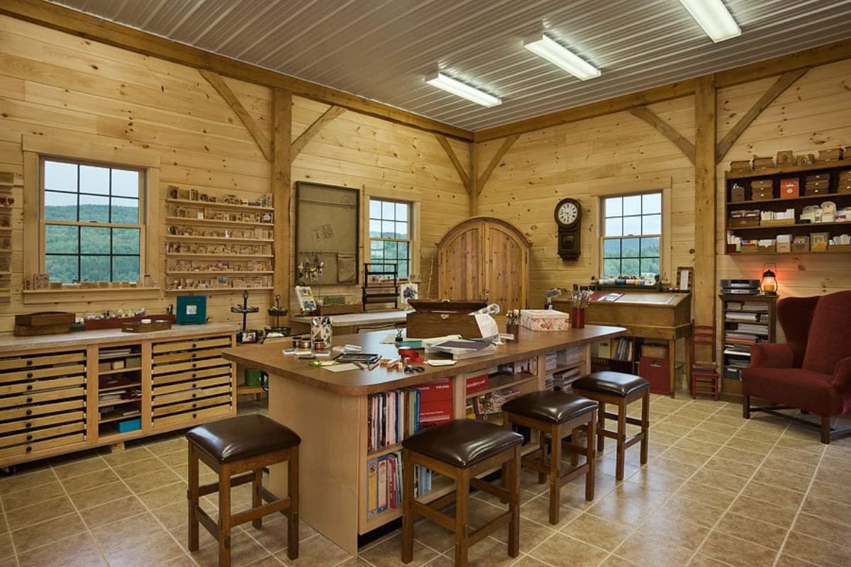 basement kitchenette with island including shelf of cookbooks and brown stools