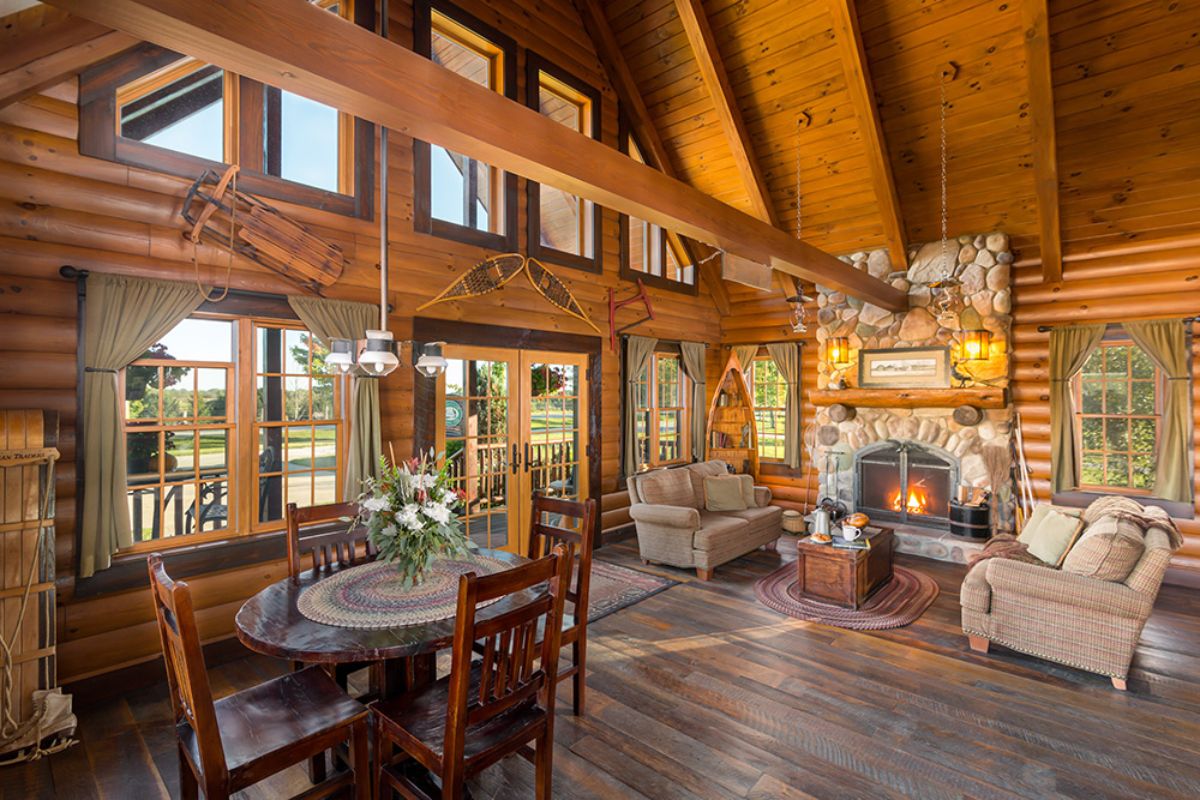 round dining table in foreground with fireplace in right background