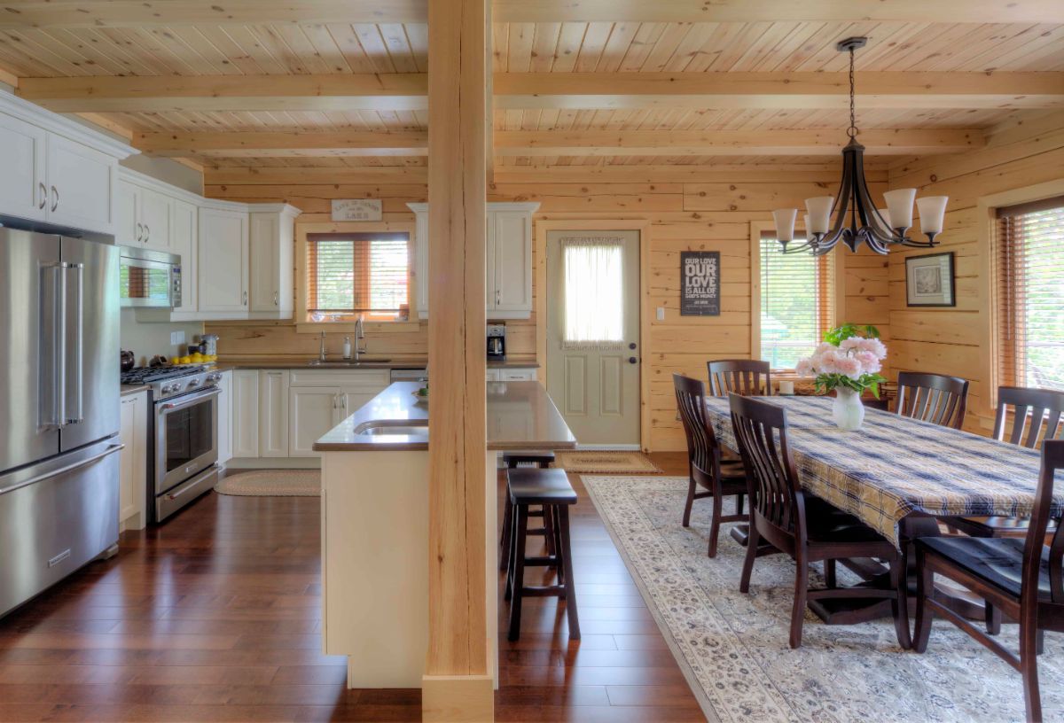 kitchen with light cabinets and table on right side