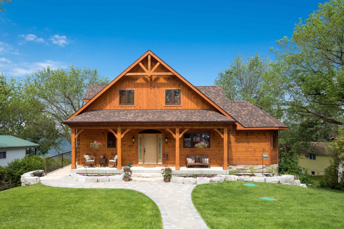 front of log home with white stone walkway and open front porch