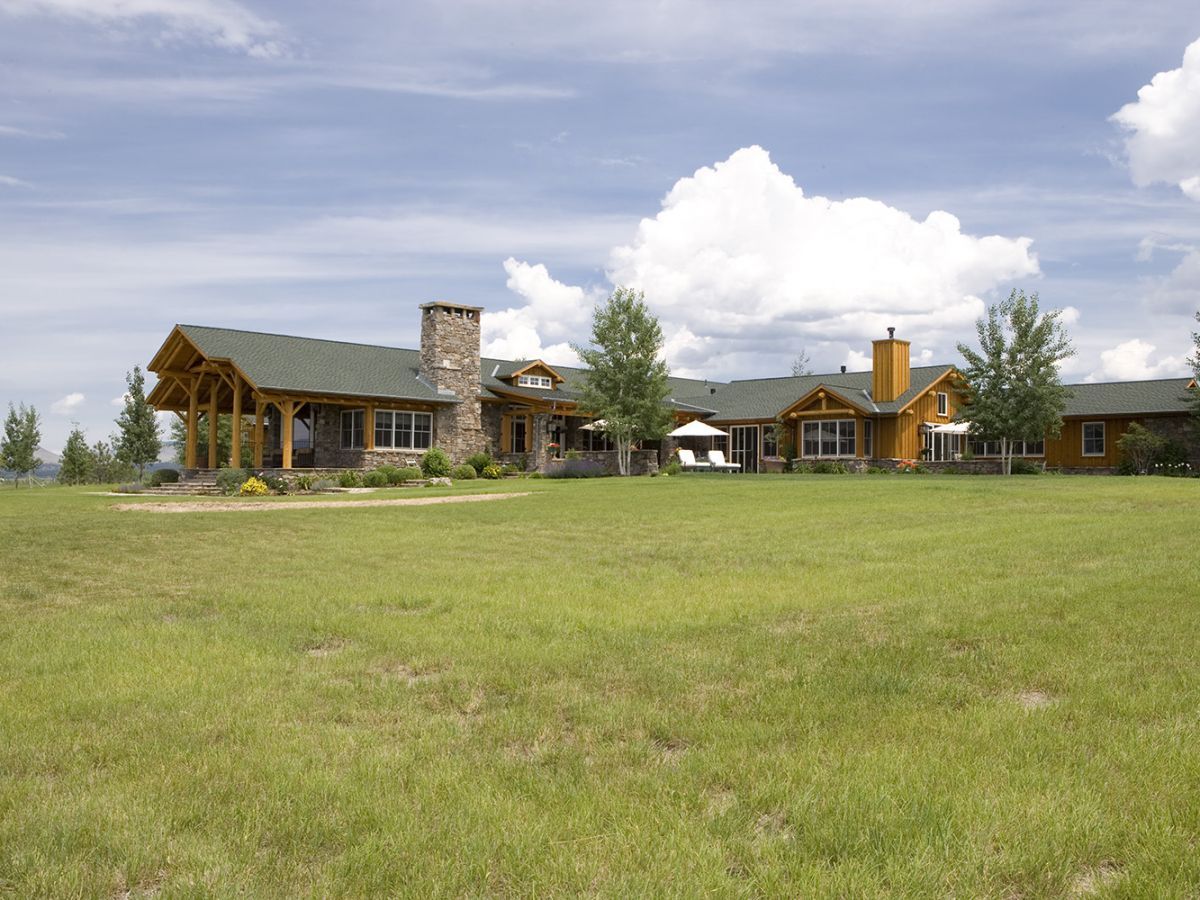 cabin against blue skies with large green yard