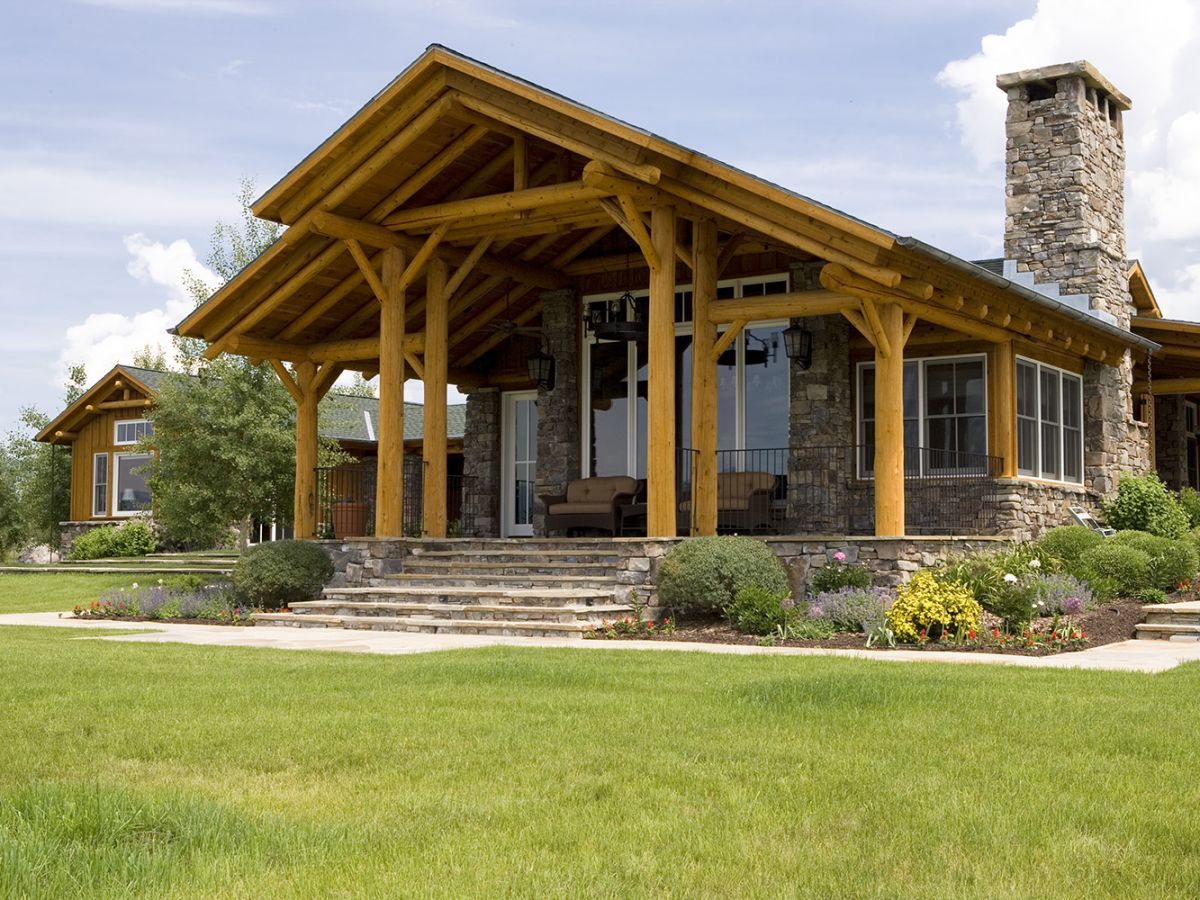 front awning over door to log cabin with stone steps