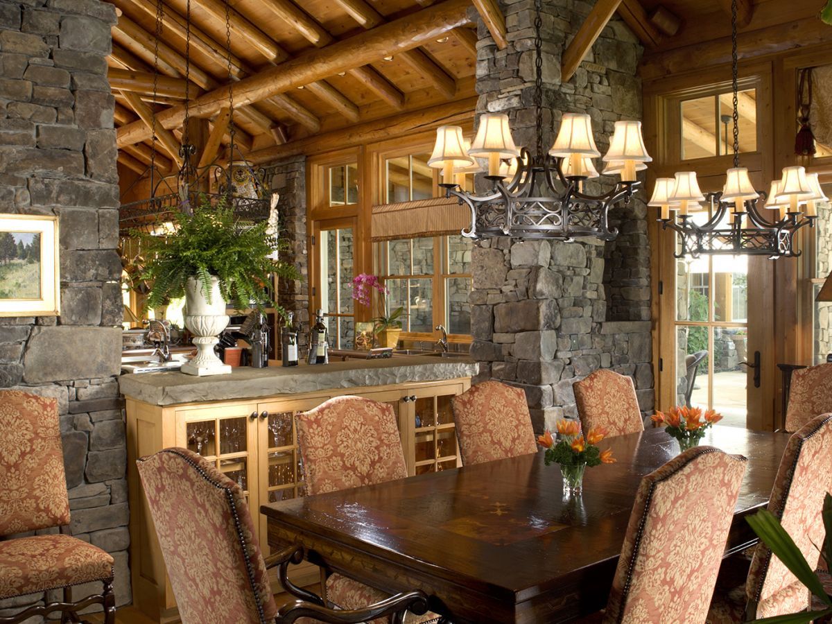 dining table under chandelier with pink upholstered chairs