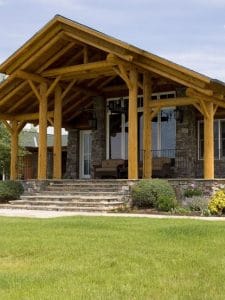 front awning over door to log cabin with stone steps