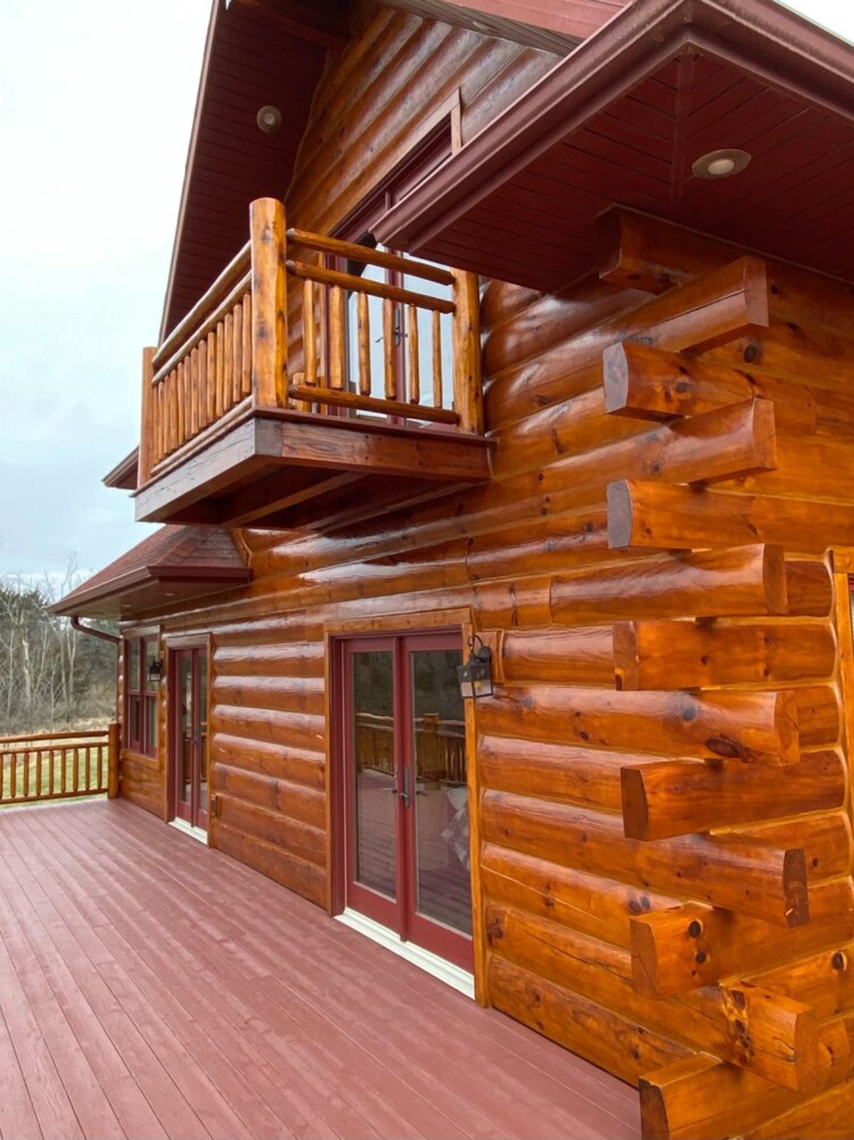 log cabin deck with small balcony on top floor