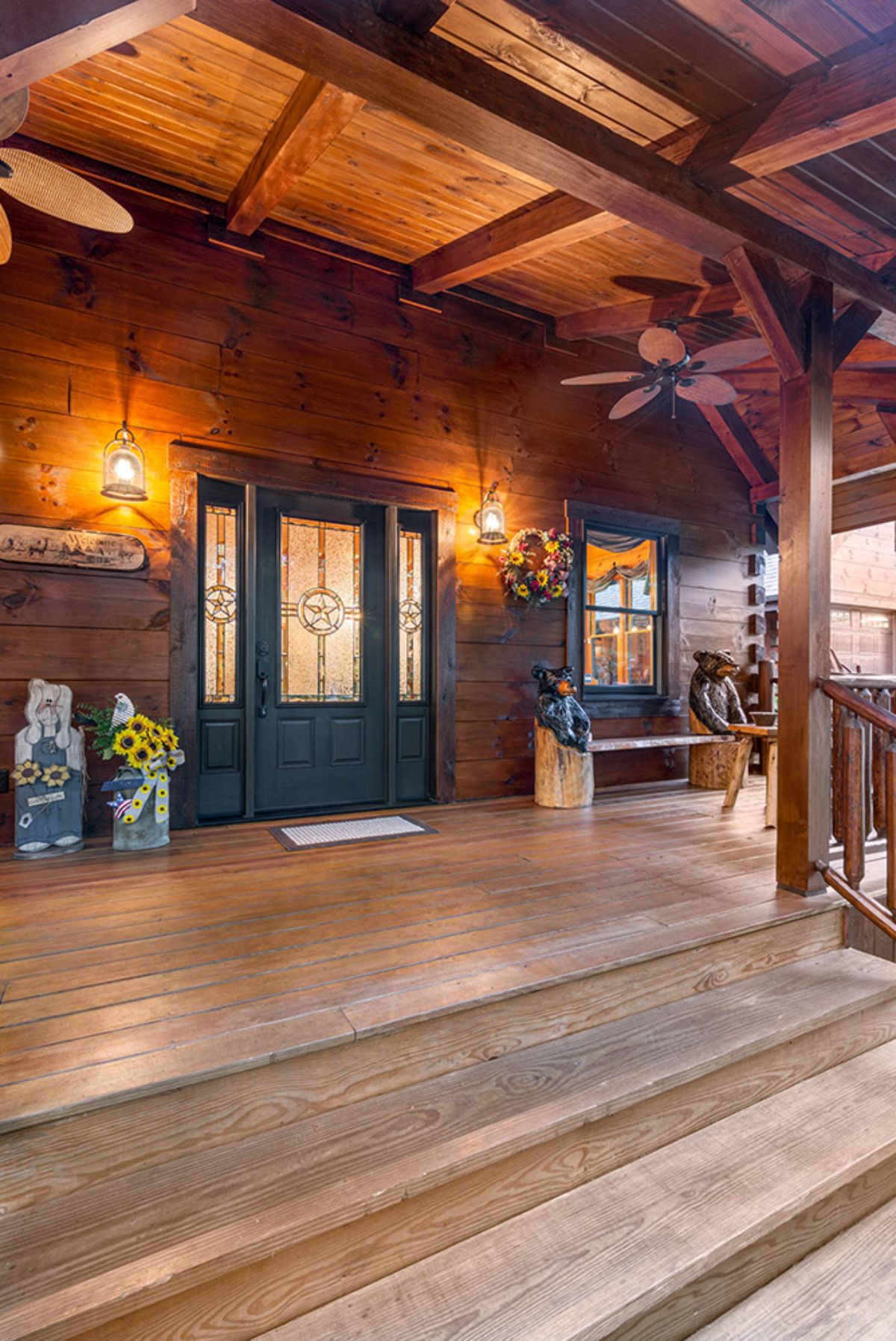 log cabin front porch with green door and bench seat next to door