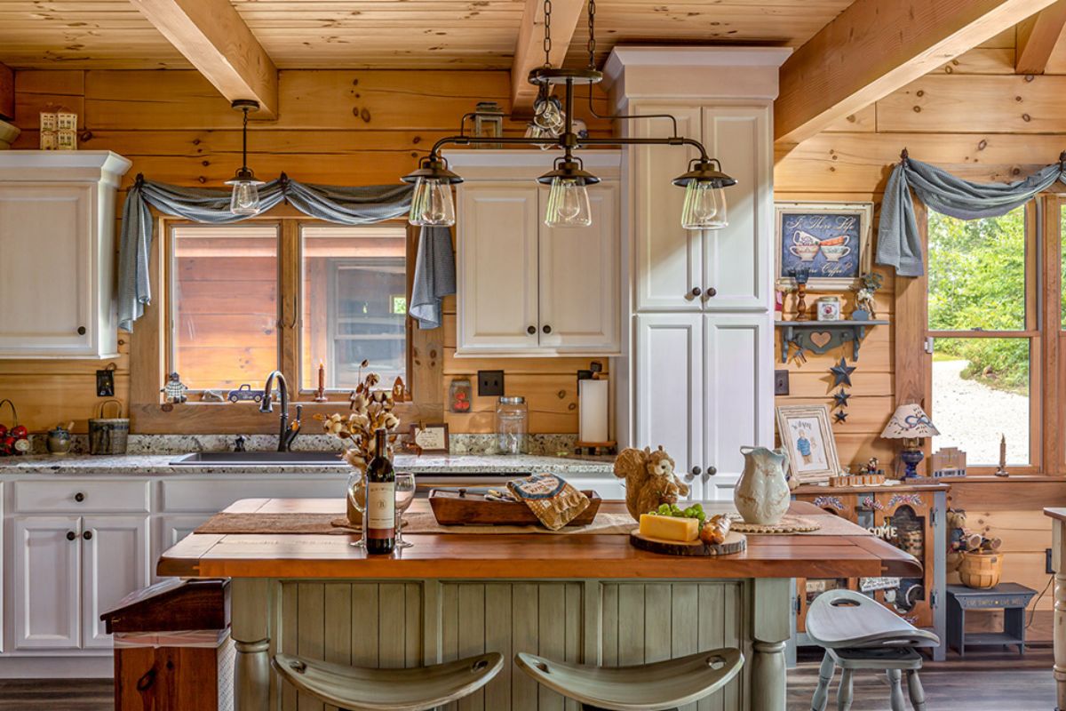 white pantry cabinets in front of kitchen islad with bowl of fruit and place setting