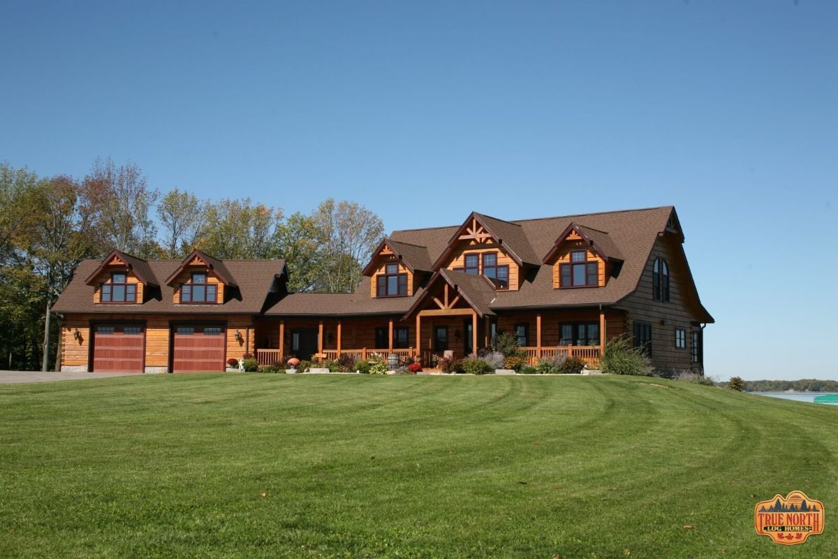 log cabin with attached garage and dormer windows