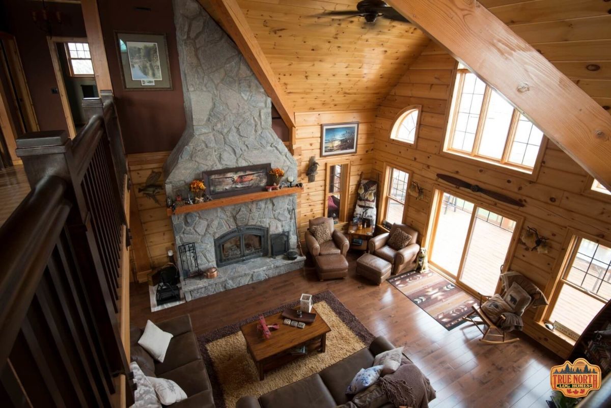 view of stone fireplace against wall of cabin