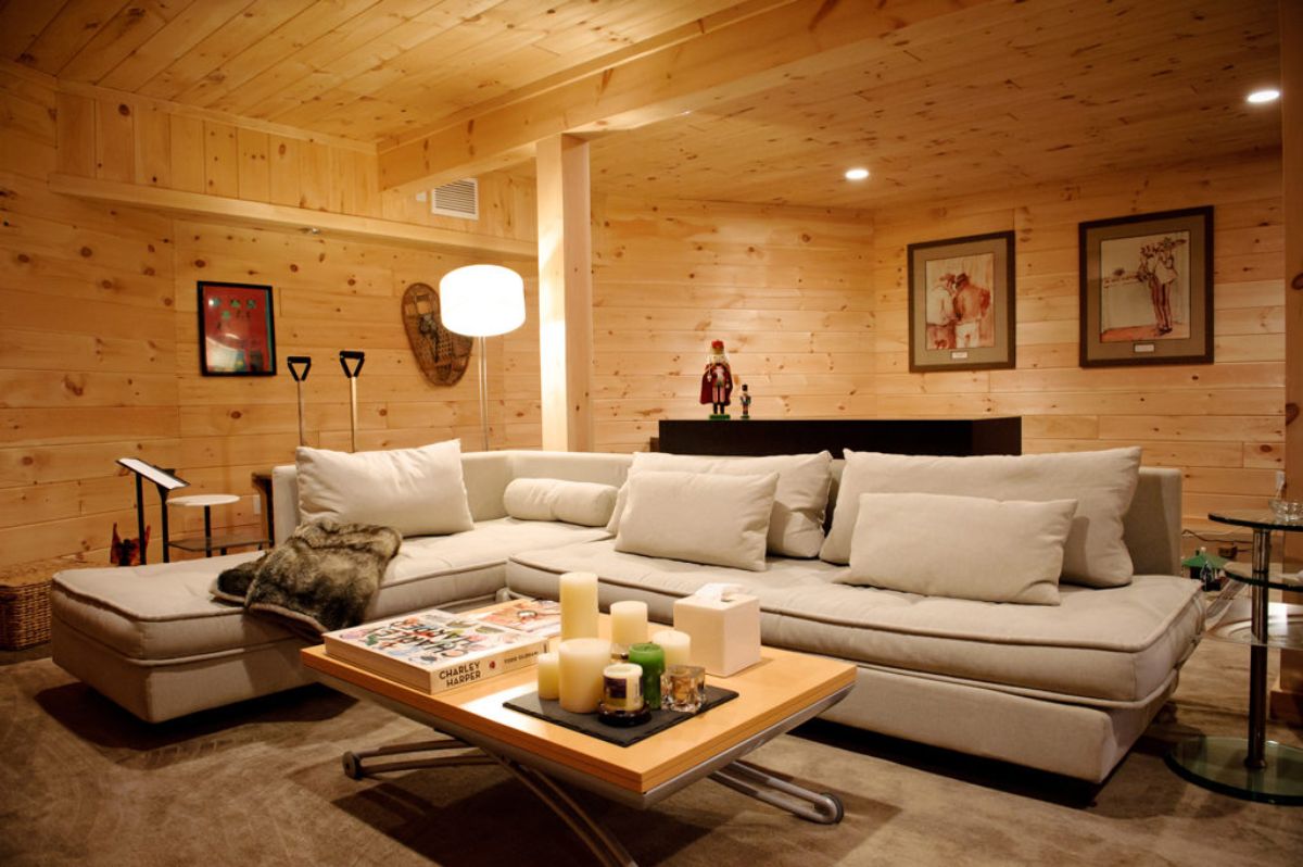 ceram sofa with light wood coffee table in front in basement