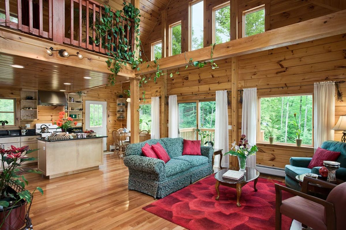 red rug underneath gray sofa in great room of log cabin