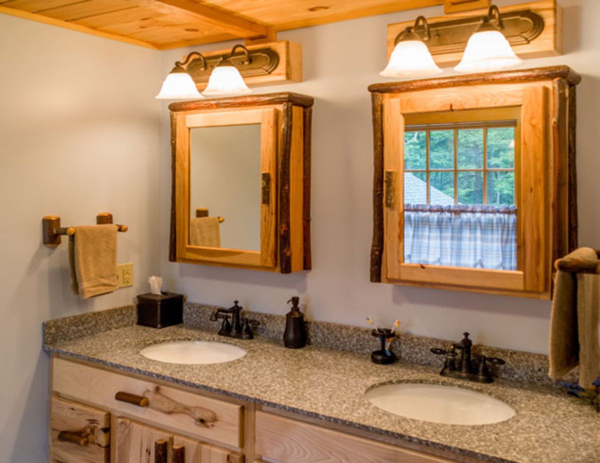 dual vanity with granite countertop and wood medicine cabinets above both white sinks