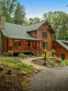 log cabin with circle walkway and green roof