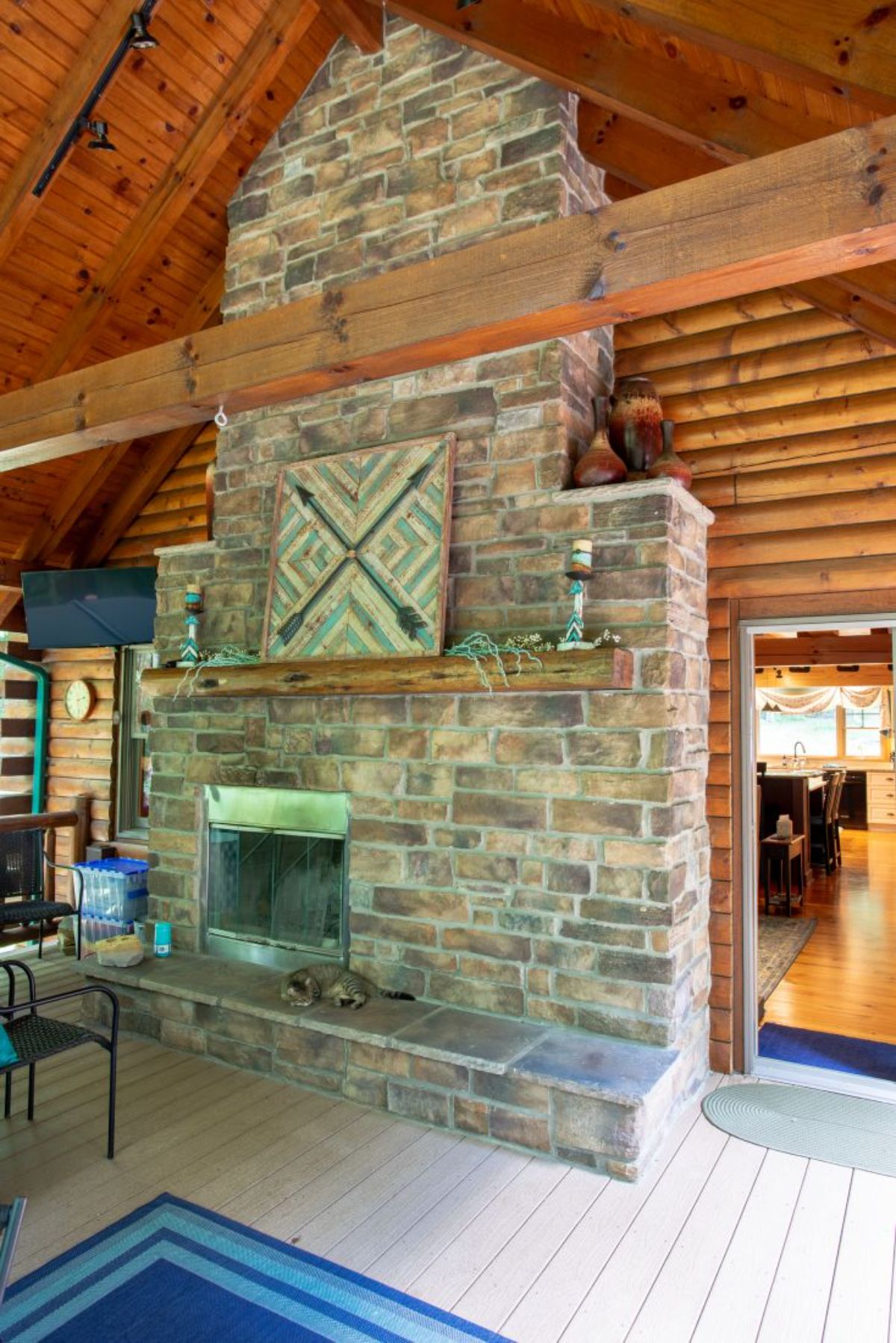 fireplace with doorways on both sides inside log cabin