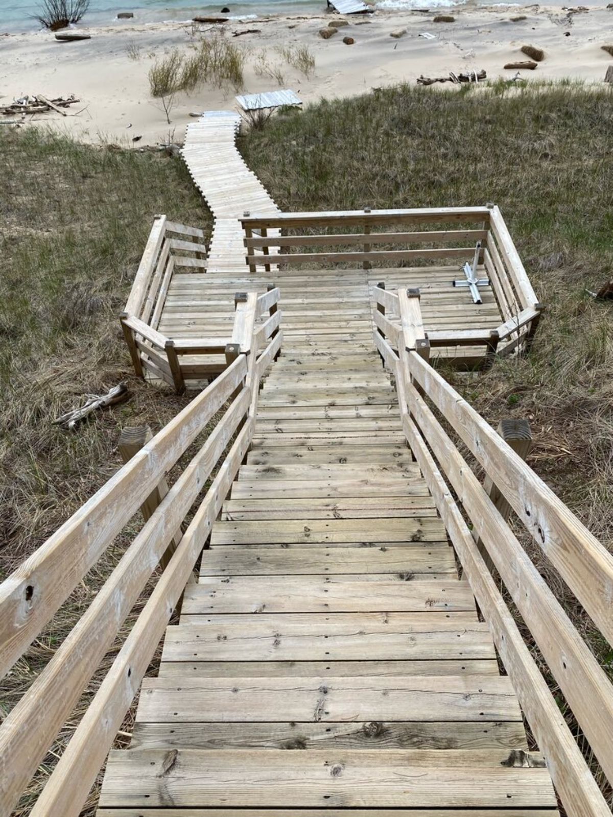 unfinished wood walkway down to beach