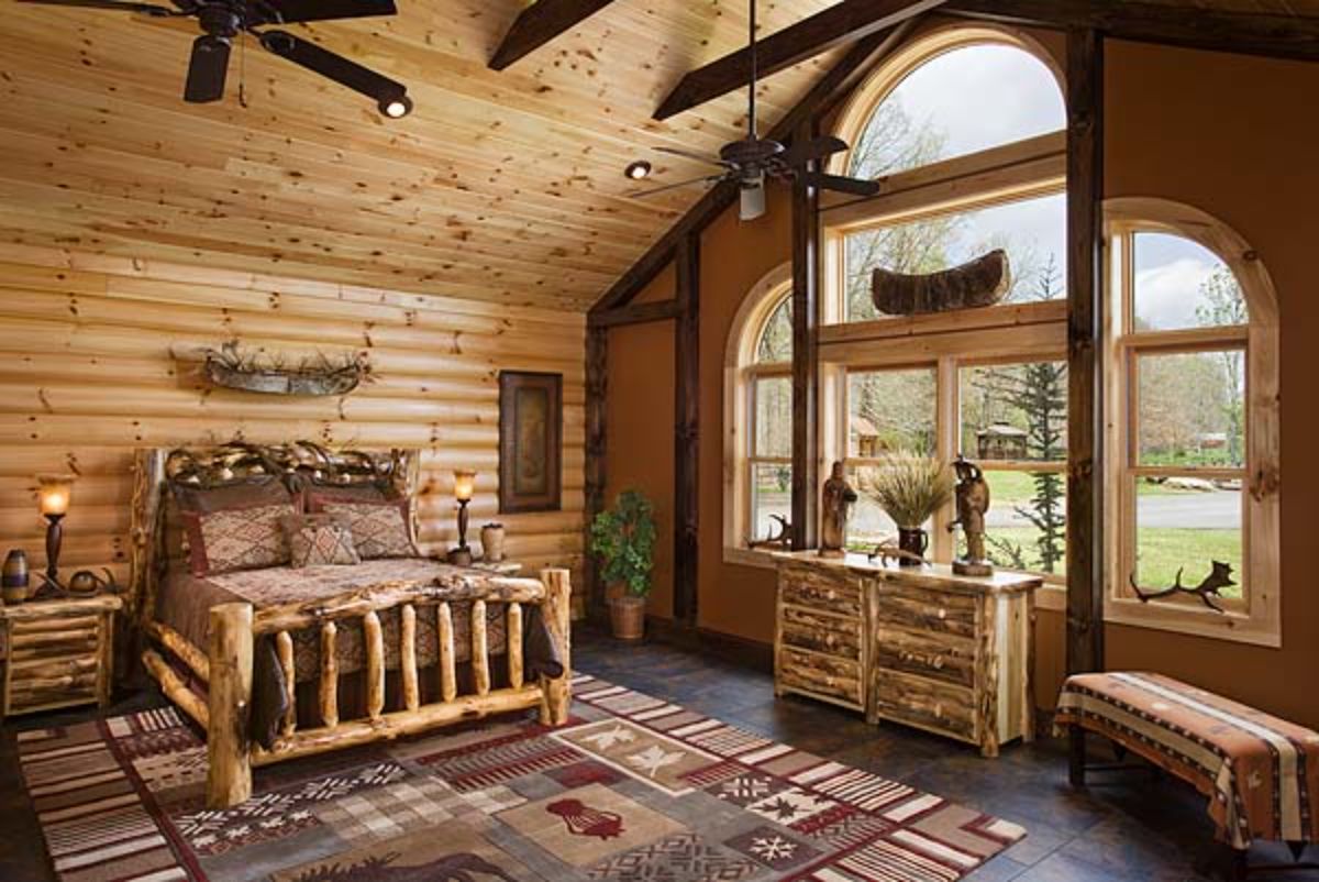 tall window on edge of bedroom with log bed frame and rug underneath bed