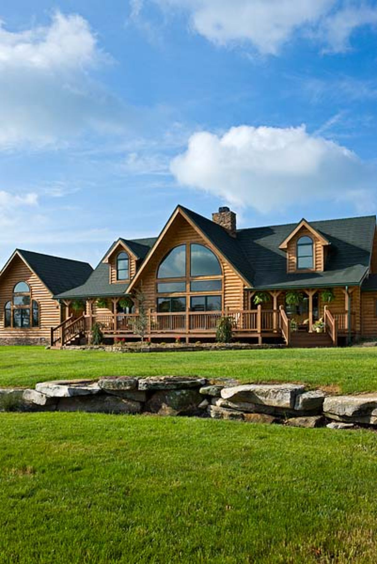 log cabin with green roof in front of rock wall