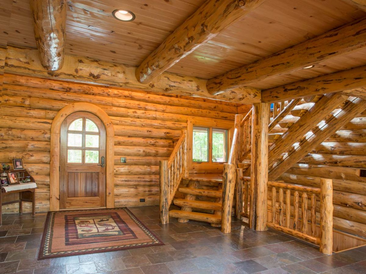 front entry to log cabin with stairs to the right of door