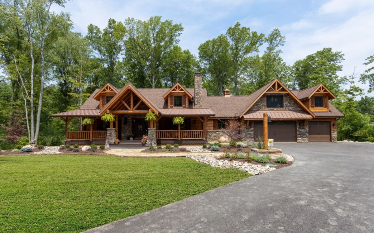 front of sprawling log cabin with stone accents and walkway