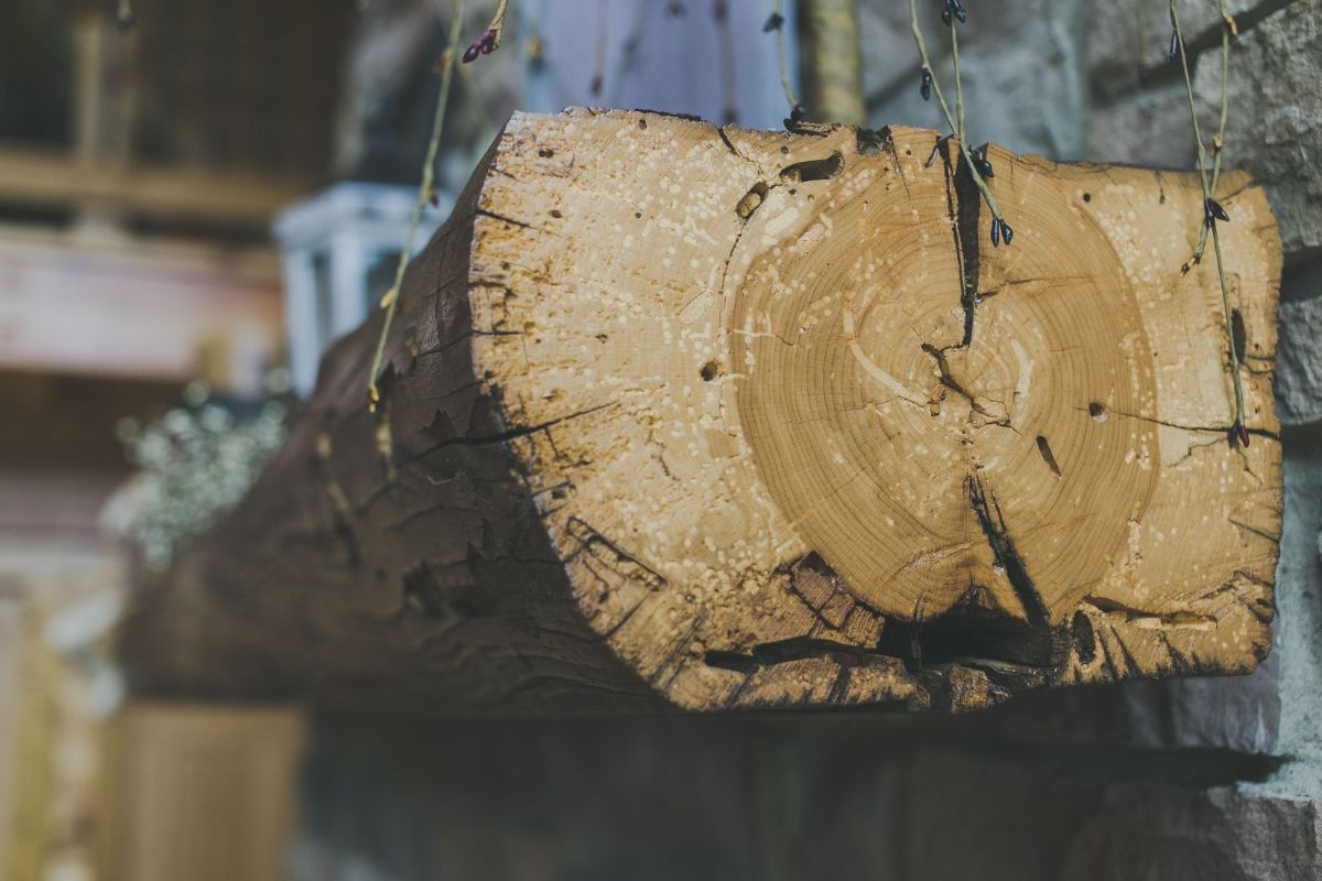 live edge mantle on stone fireplace