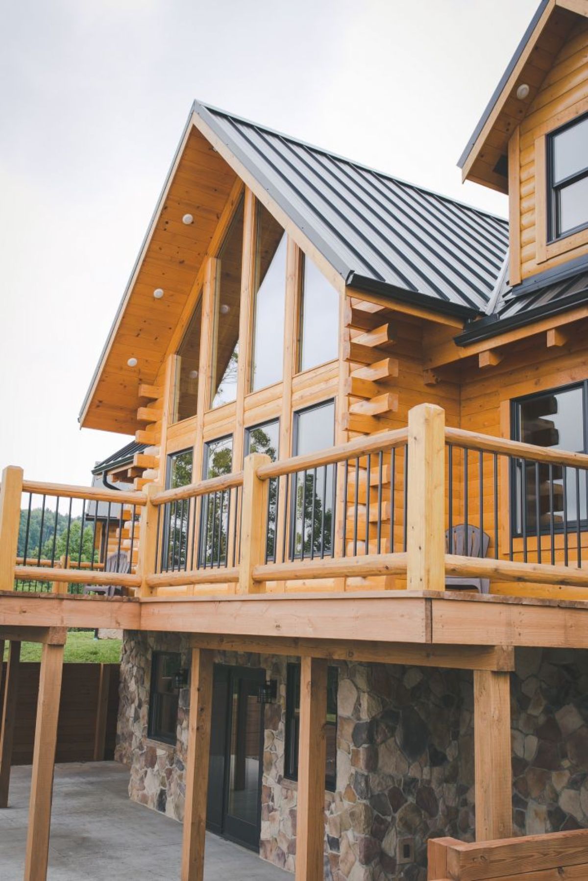 uncovered deck on log cabin by great room windows