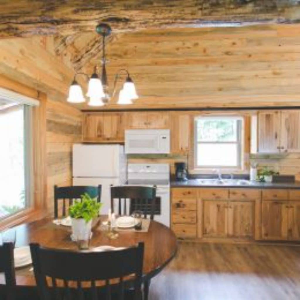 round table on left with kitchen along back wall