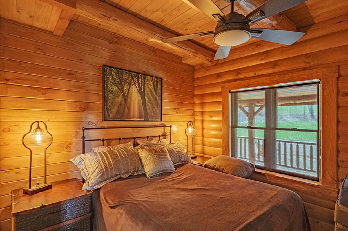 bedroom with window on right side of room and ceiling fan above bed