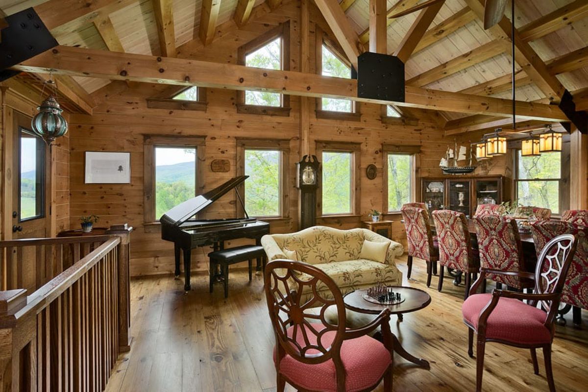 baby grand piano in background near windows with cream and marron vintage chairs in foreground