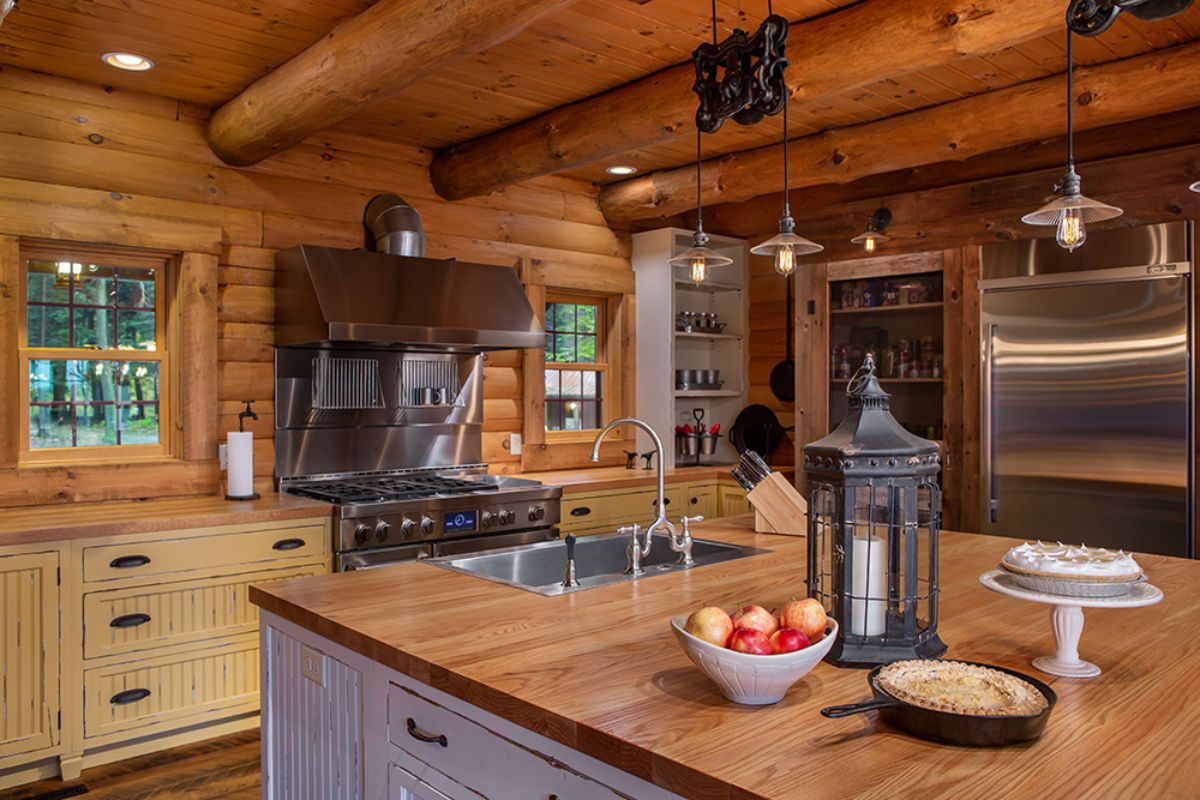 white cabinets beneath butcher block countertops in kitchen