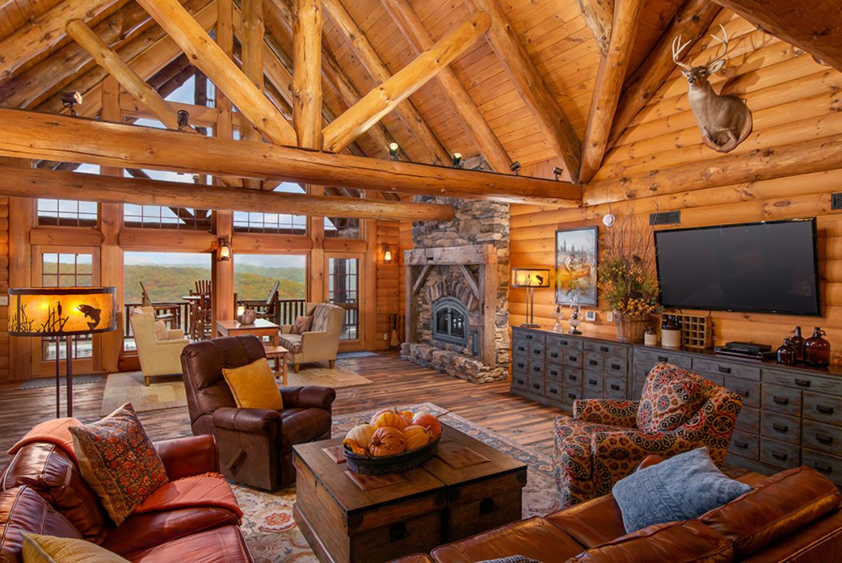 brown leather recliner with maroon sofas and fireplace in background