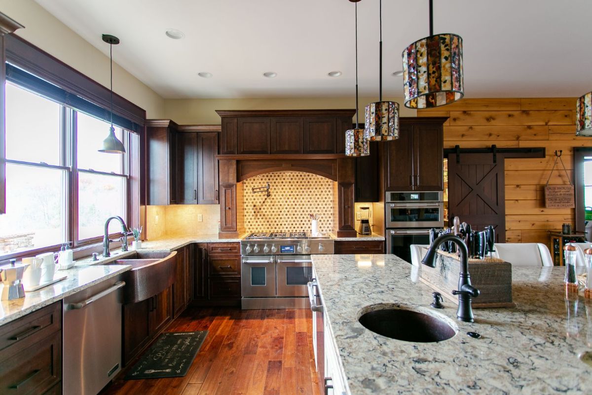 dark cabinets with light granite countertops in kitchen