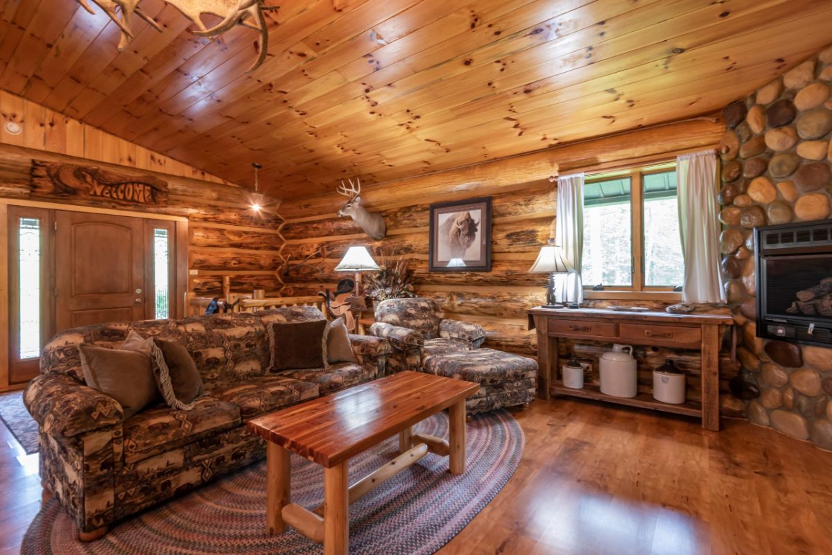 log cabin living room with small wood coffee table in front of sofa