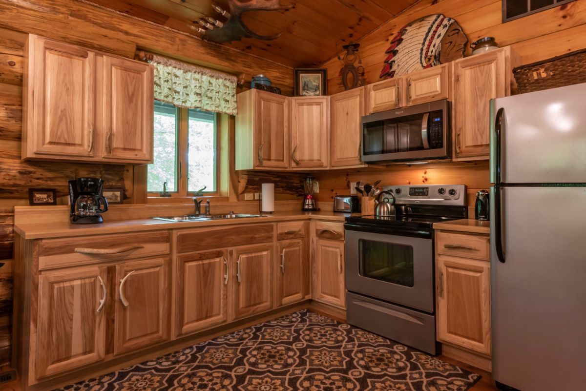 kitchen with wood cabinets and stainless steel stove and microwave on right side of image