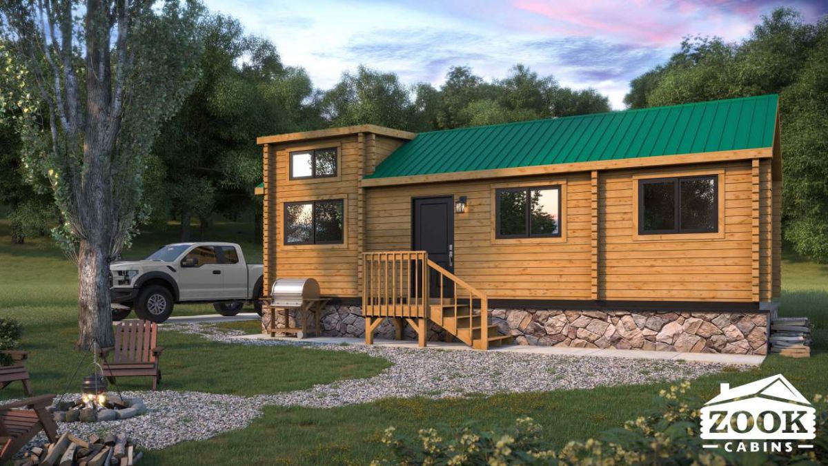 kitchen and dining space to the side of log cabin with black refrigerator