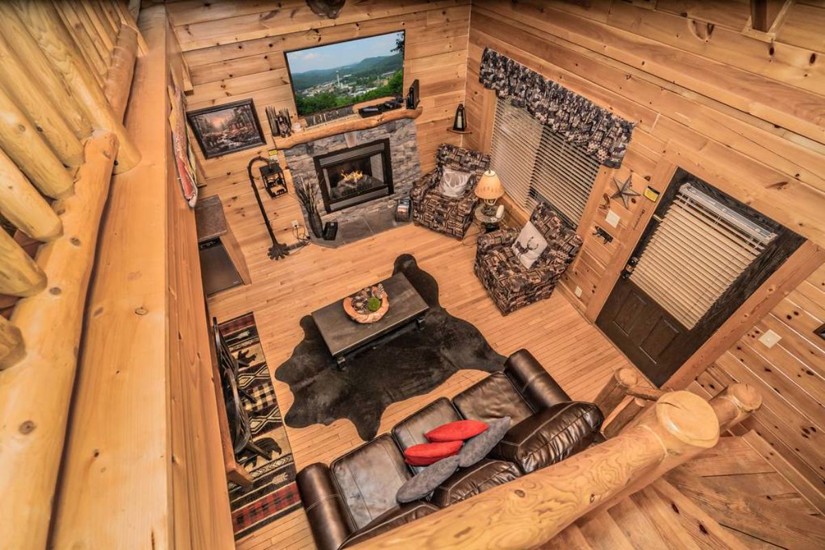 view from loft into main floor living space in log cabin