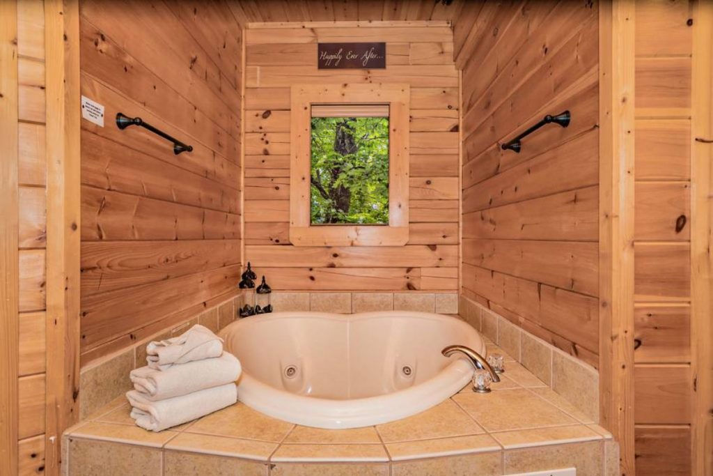 white heart shaped soaking bathtub in log cabin bathroom