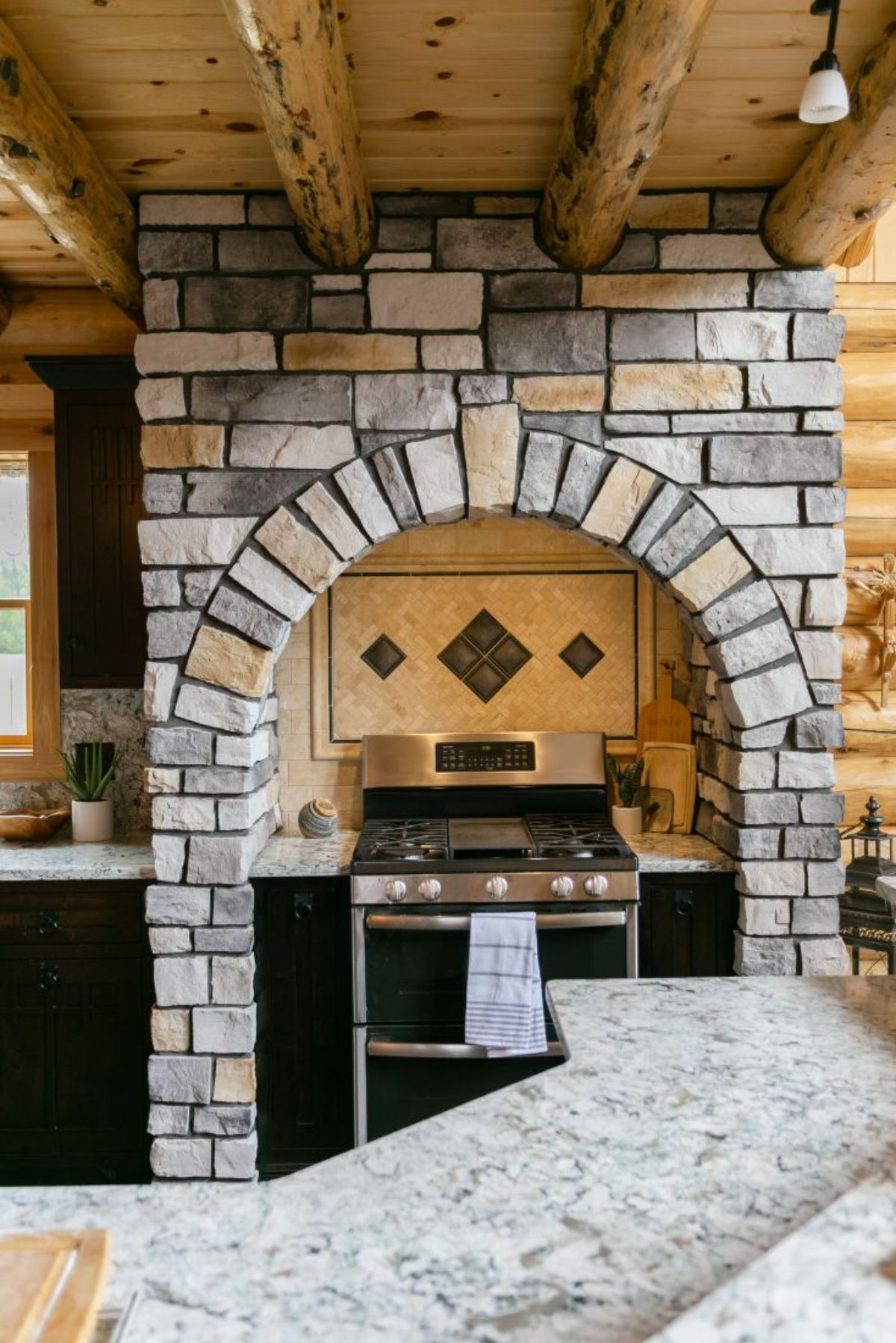 stove against cream wall with custom tile background and stone surround