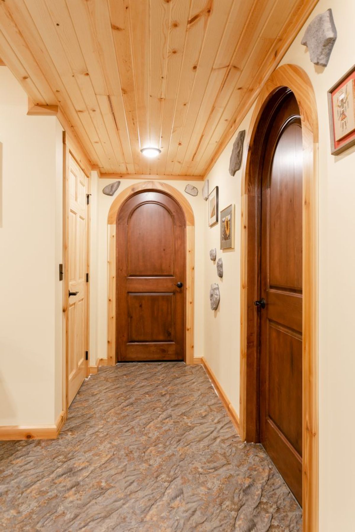 hall with cream walls and wood arch doorways