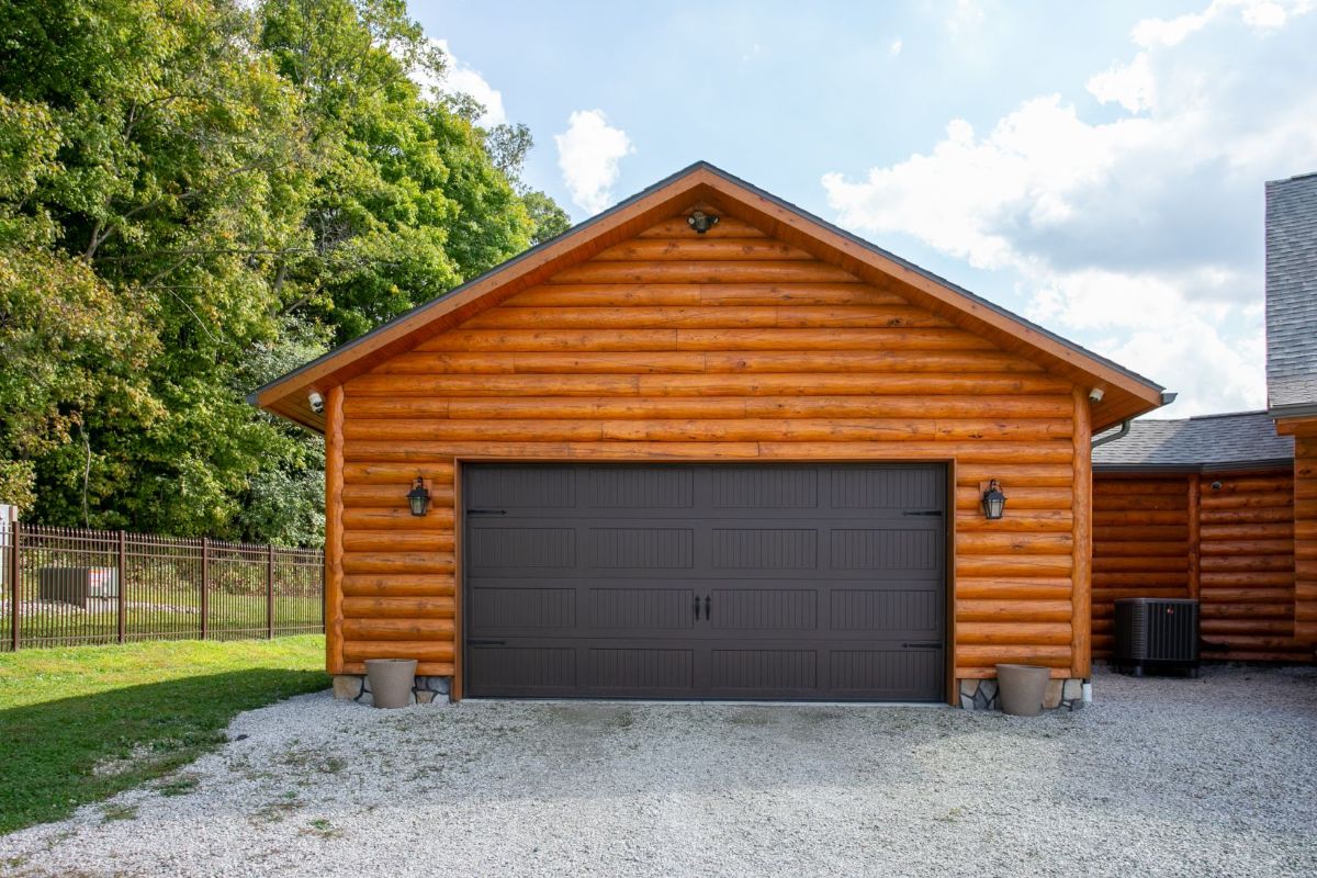 log cabin garage with charcoal gray door