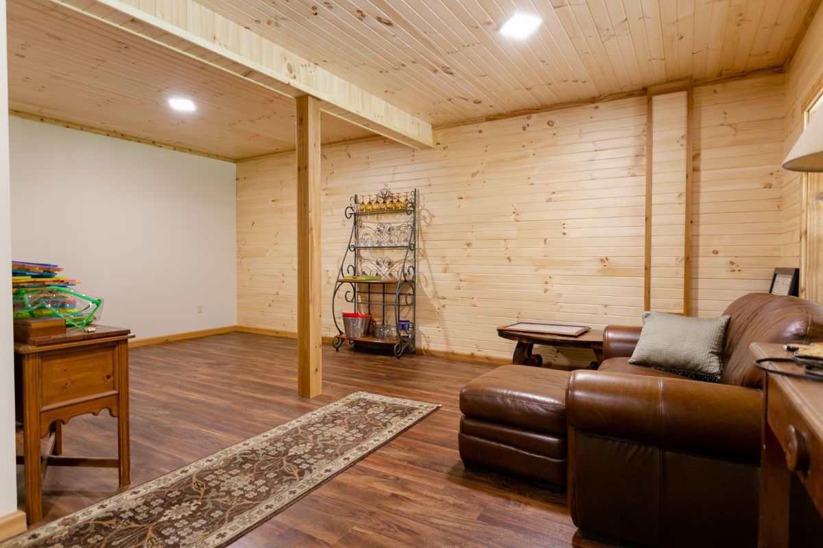 open space in basement with wood walls
