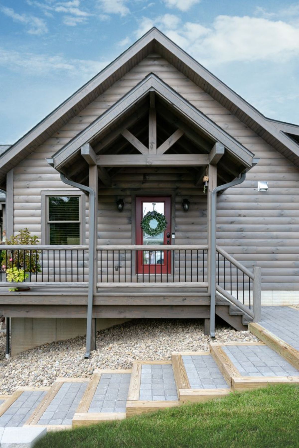 light gray wood cabin with brown wood door