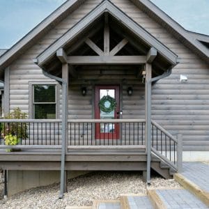 light gray wood cabin with brown wood door