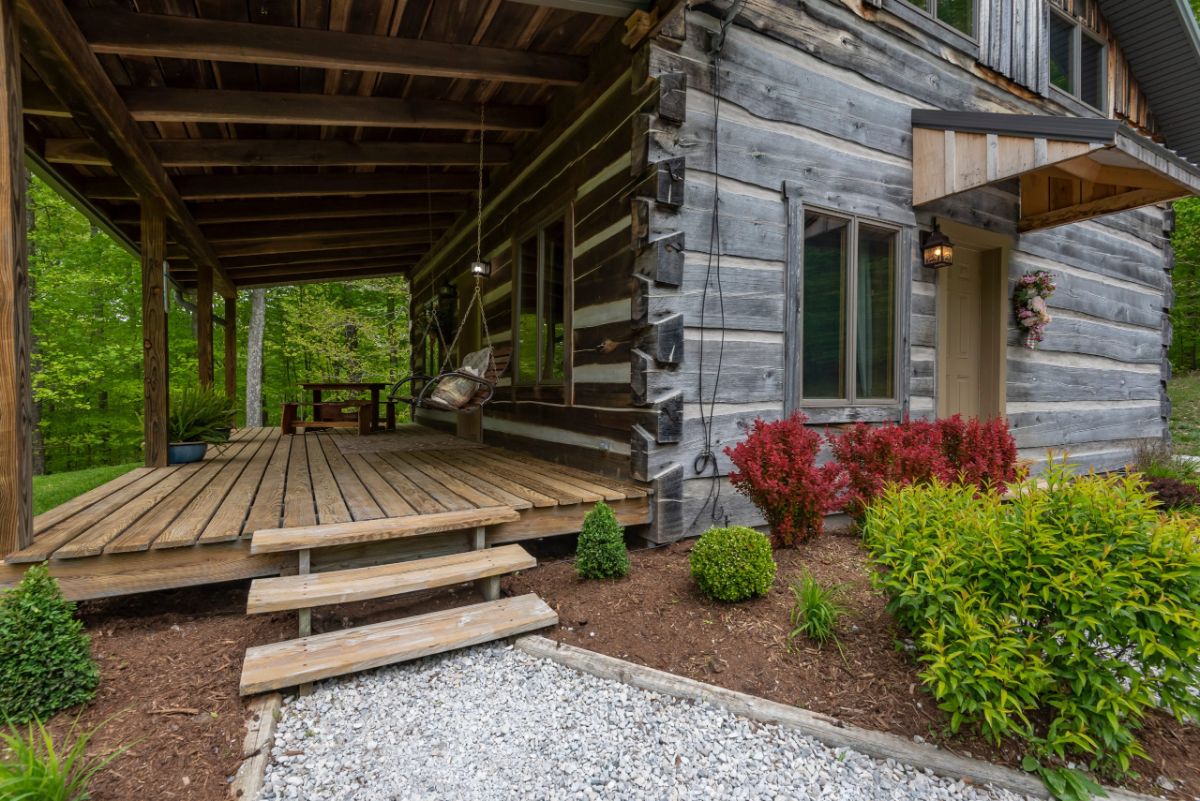 wood porch and steps up to front of log cabin